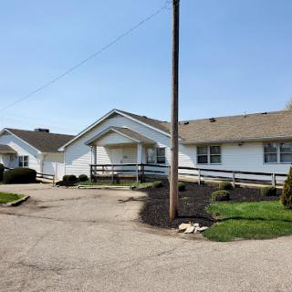 A sunny day view of a residential building with well-maintained landscaping.