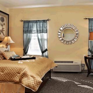 A cozy bedroom with warm decor and stylish furniture.