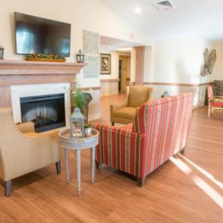 A cozy living room with a fireplace, television, and comfortable seating.