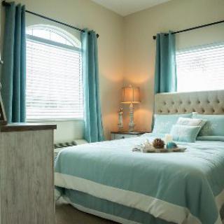 A cozy bedroom with teal accents and soft lighting.