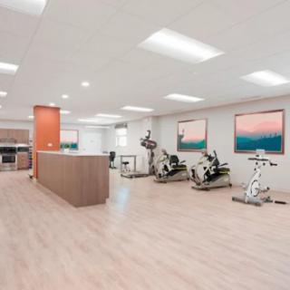 A spacious and minimalist gym with exercise equipment set up for workouts.