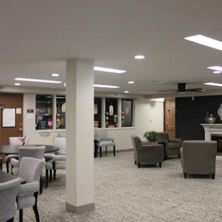 A spacious and modern lounge area featuring comfortable seating and ambient lighting.