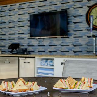Plates of sandwiches on a table in a modern kitchen setting.