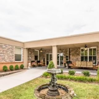 A serene courtyard with a central fountain and outdoor seating area.