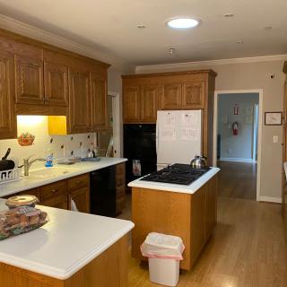 A cozy kitchen with wooden cabinets, an island, and modern appliances.