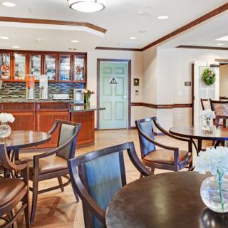 A cozy lounge interior with seating and a bar area.