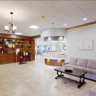 A modern and inviting waiting room featuring comfortable seating and elegant wooden accents.