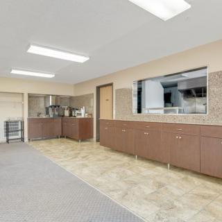 A spacious, modern kitchen with ample cabinetry and sleek lighting.