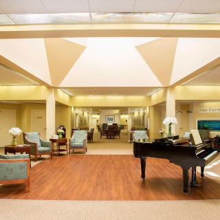Elegant hotel lobby with a grand piano and comfortable seating.