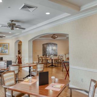 A spacious and elegantly decorated dining area with neatly arranged tables and chairs.