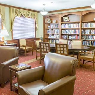 A cozy reading room with comfortable seating and bookshelves.