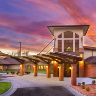 A beautiful building entrance illuminated during sunset.