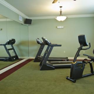A small indoor gym with treadmills and an exercise bike.