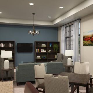 A modern living room with a blue accent wall, comfortable seating, and tasteful decor.