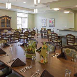 A well-decorated dining area with neatly arranged tables and chairs.