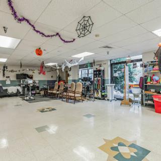 A spacious and colorful community room equipped for various activities and gatherings.