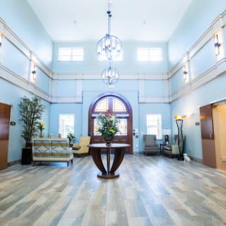 A spacious and elegantly designed lobby featuring modern decor and ample natural light.