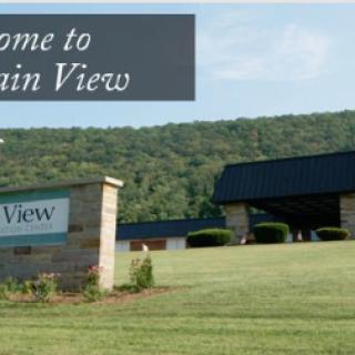 A welcoming view of the Mountain View sign amidst a lush landscape.