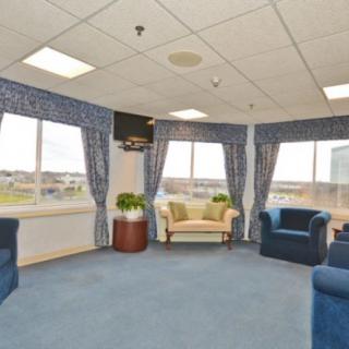 A spacious waiting room with large windows and comfortable seating.