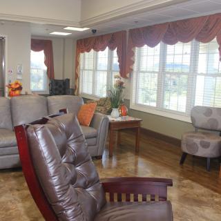 A cozy living room with comfortable seating and large windows.
