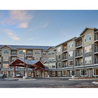 A modern multi-story apartment building with a welcoming entrance.