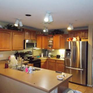 A modern kitchen with wooden cabinets and stainless steel appliances.