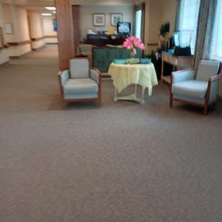 A welcoming waiting area featuring comfortable chairs and a decorative table.
