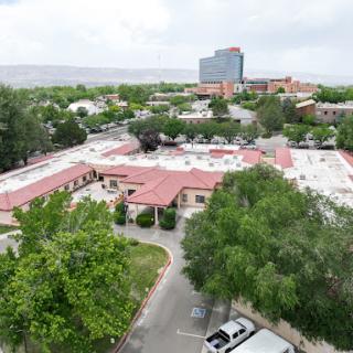 Aerial view of a suburban area featuring a mix of low-rise and high-rise buildings surrounded by greenery.