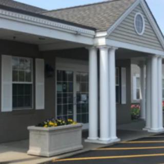 A building entrance with columns and a planter.