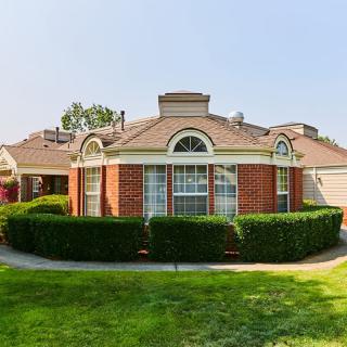 A suburban house with a brick exterior and well-maintained landscaping.