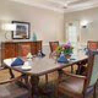 A well-furnished dining room with a table set for a meal.