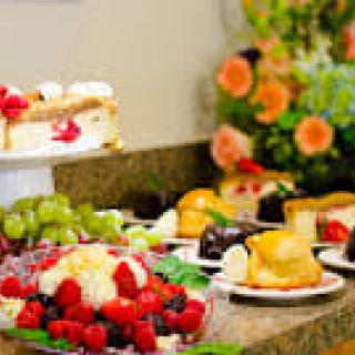 A lavish dessert buffet featuring cakes and fresh fruits.