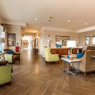 A modern hotel lobby with comfortable seating and reception desk.