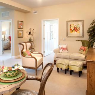 A cozy living room with traditional furniture, decorative pillows, and elegant wall art.
