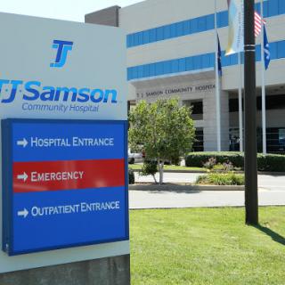 Entrance sign for TJ Samson Hospital, indicating emergency and outpatient entrances.
