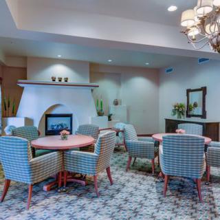 A cozy dining area with a fireplace and elegant chandelier.