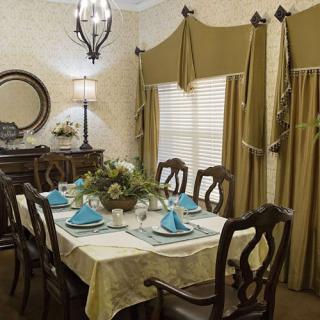 An elegantly decorated dining room with a set table and classic furnishings.