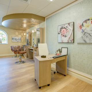 A modern salon interior with stylish decor and comfortable seating.