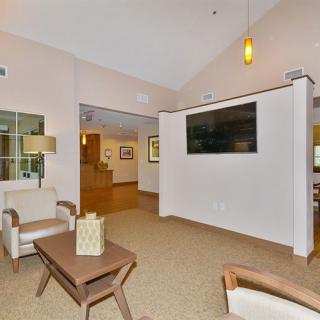 A modern living room with comfortable seating and a wall-mounted TV.