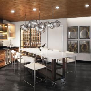 A sleek and modern dining room featuring minimalist furniture, a striking chandelier, and artistic wall decor.