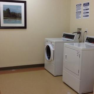 A clean and organized laundry room with a washing machine and dryer.