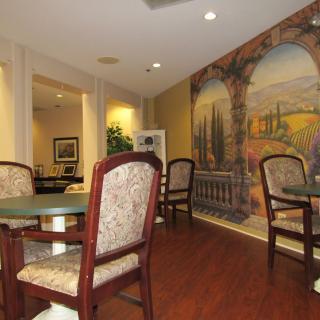 Cozy dining area with mural and wood flooring.