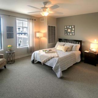 A modern and cozy bedroom with neutral colors and stylish decor.