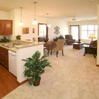 An open-concept living space with a kitchen, dining area, and comfortable seating.
