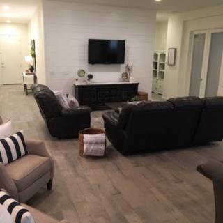 A modern and cozy living room setup, featuring comfortable seating and a television.