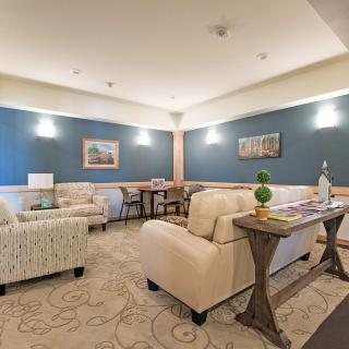 A cozy living room with comfortable seating, elegant decor, and soft lighting.