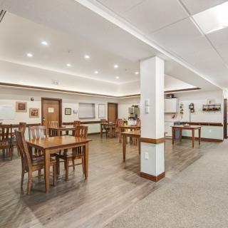 A spacious and well-lit dining area with wooden tables and chairs.