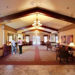 A spacious lobby area with a reception desk and comfortable seating.
