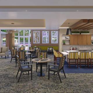 A modern dining area with comfortable seating and ample lighting.