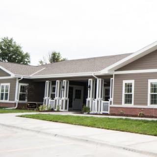 A modern residential building featuring a welcoming entrance and well-maintained landscaping.